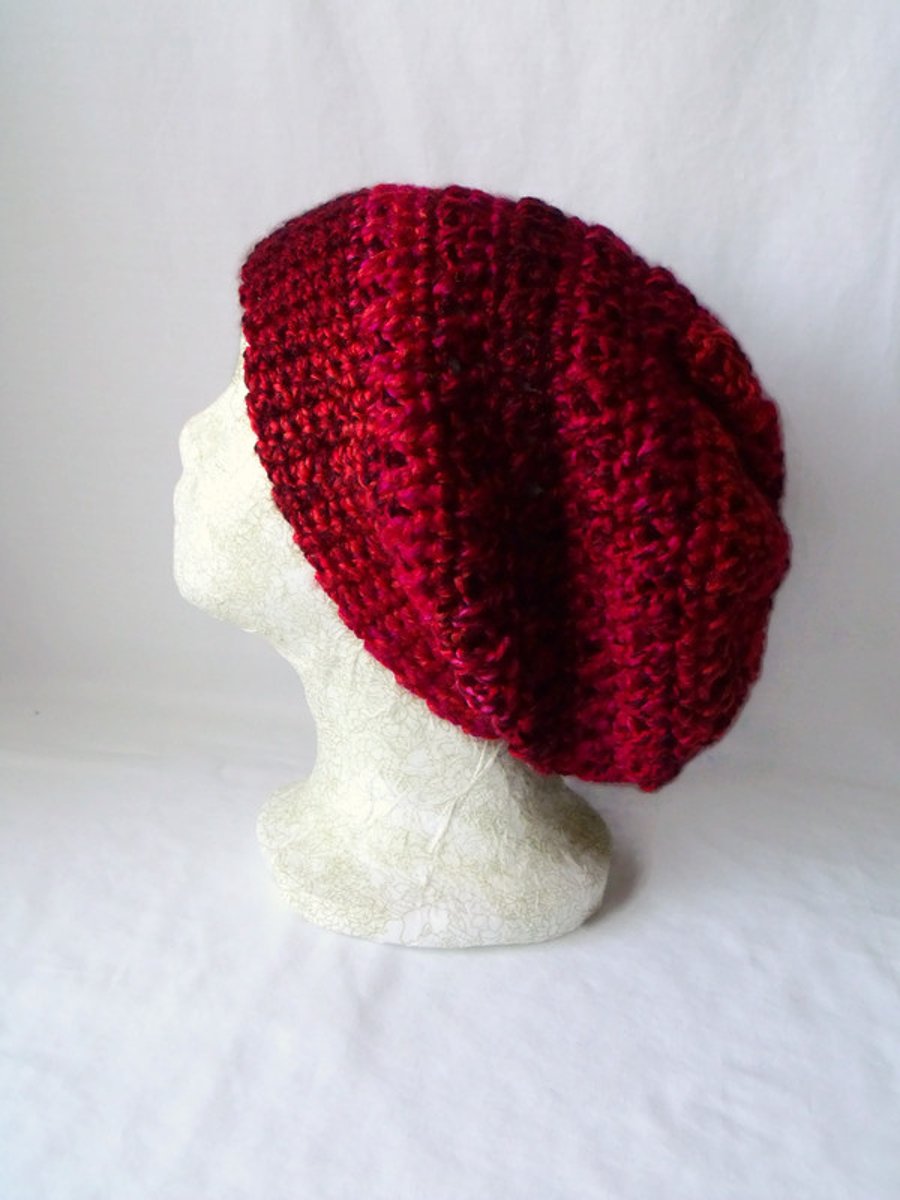red crocheted slouchie beanie hat with criss cross stitches