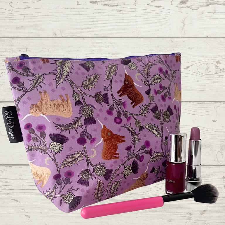 Makeup bags highland cows and silver thistles.