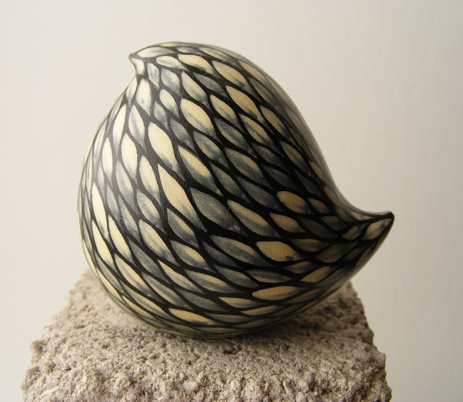 Cream on black painted bird