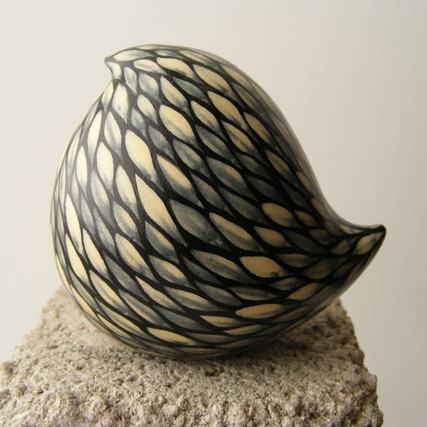 Cream on black painted bird