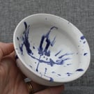 White bowl with blue paint splatter
