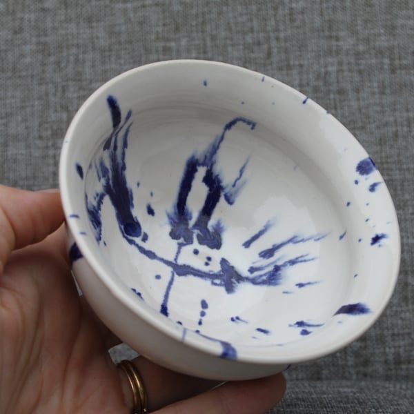 White bowl with blue paint splatter