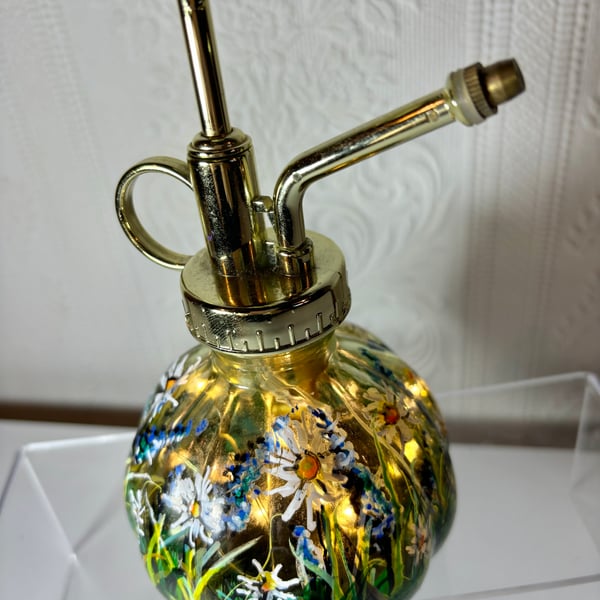 A hand painted and fired glass plant spray mister