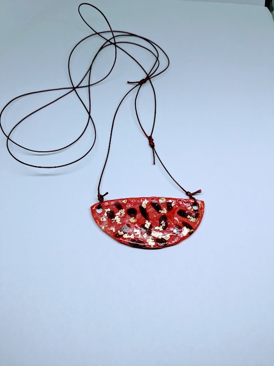 A fun modern polymer clay moon shaped necklace, pink and gold