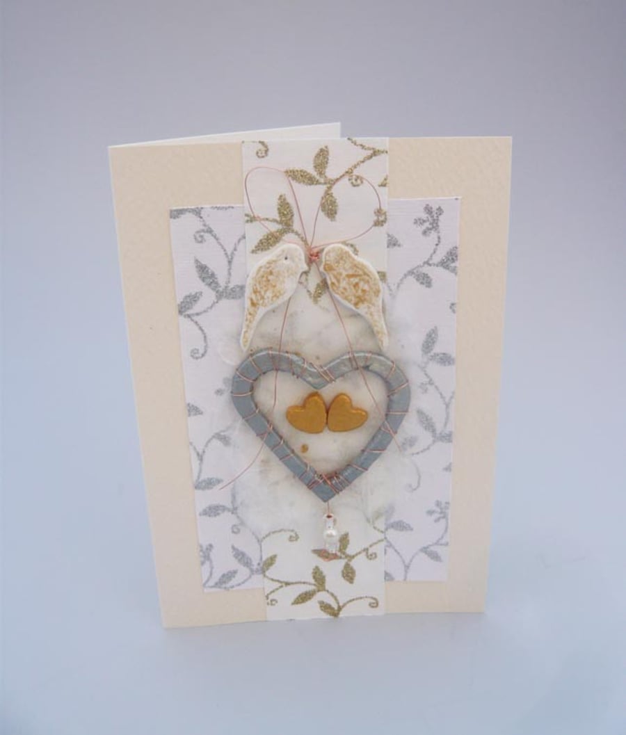 Wedding card with silver heart and birds.
