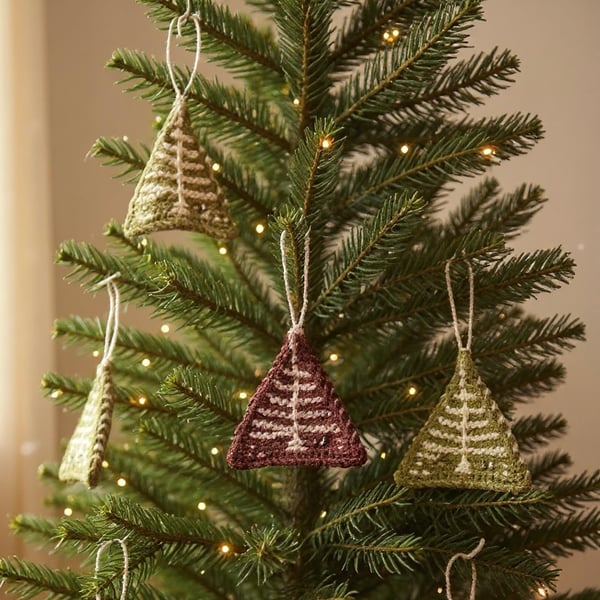 Set of 7 knitted mini Christmas tree decorations in green