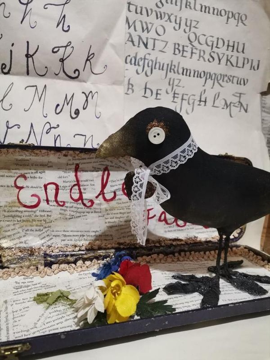 A vintage style textile art sculpture bird, mixed media art sculpture, poetry