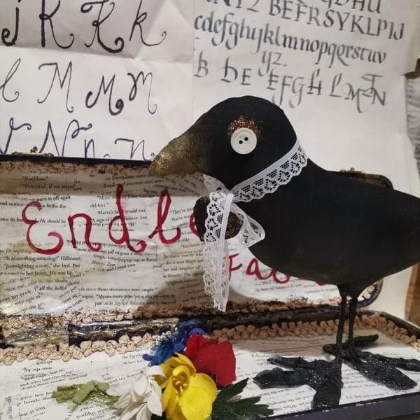 A vintage style textile art sculpture bird, mixed media art sculpture, poetry