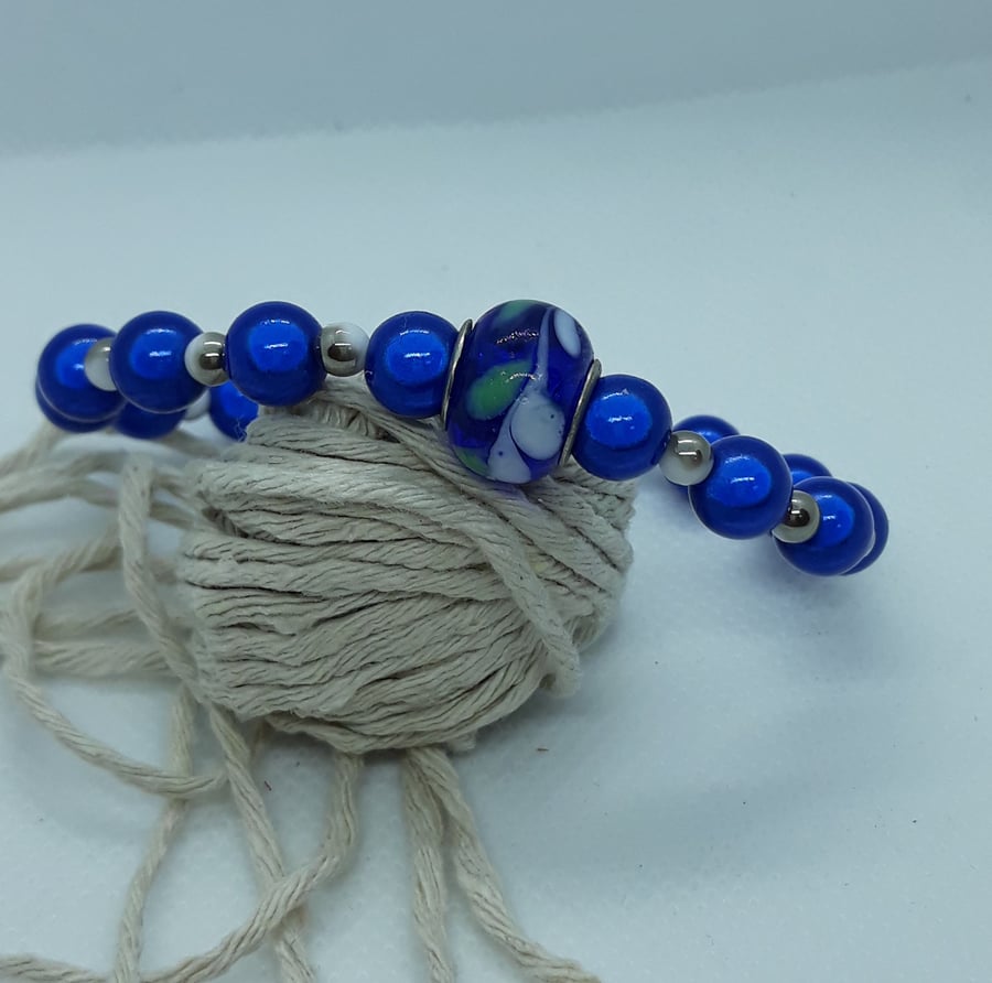 BR371 Blue miracle bead bracelet with glass feature bead