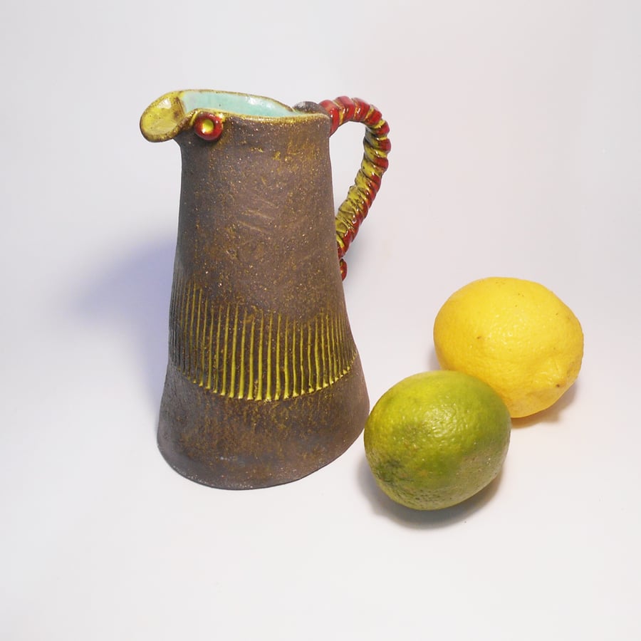 Black Clay Ceramic Jug with Blue, Yellow and red glaze colours.