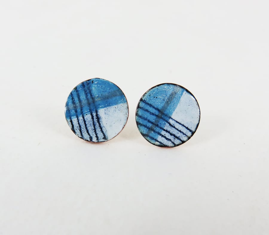 Round copper stud earrings with blue, white and silver enamel and drawn detail.