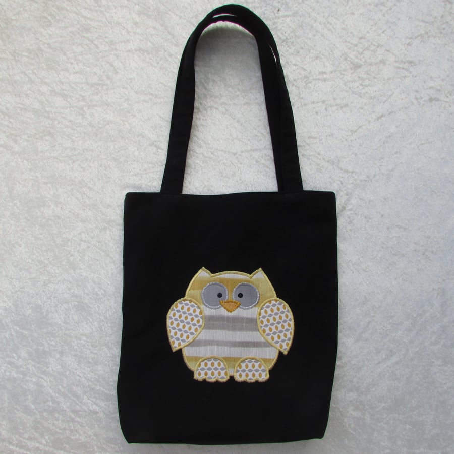 Black tote bag with white, grey and golden yellow appliqued owl