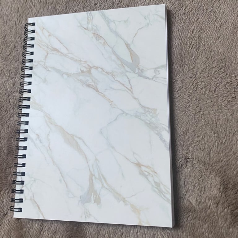 White, Gold Marble A5 Lined Spiral binded notebook.