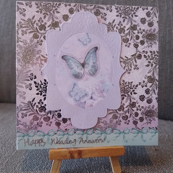 a preety decorate card with a butterfly in the center