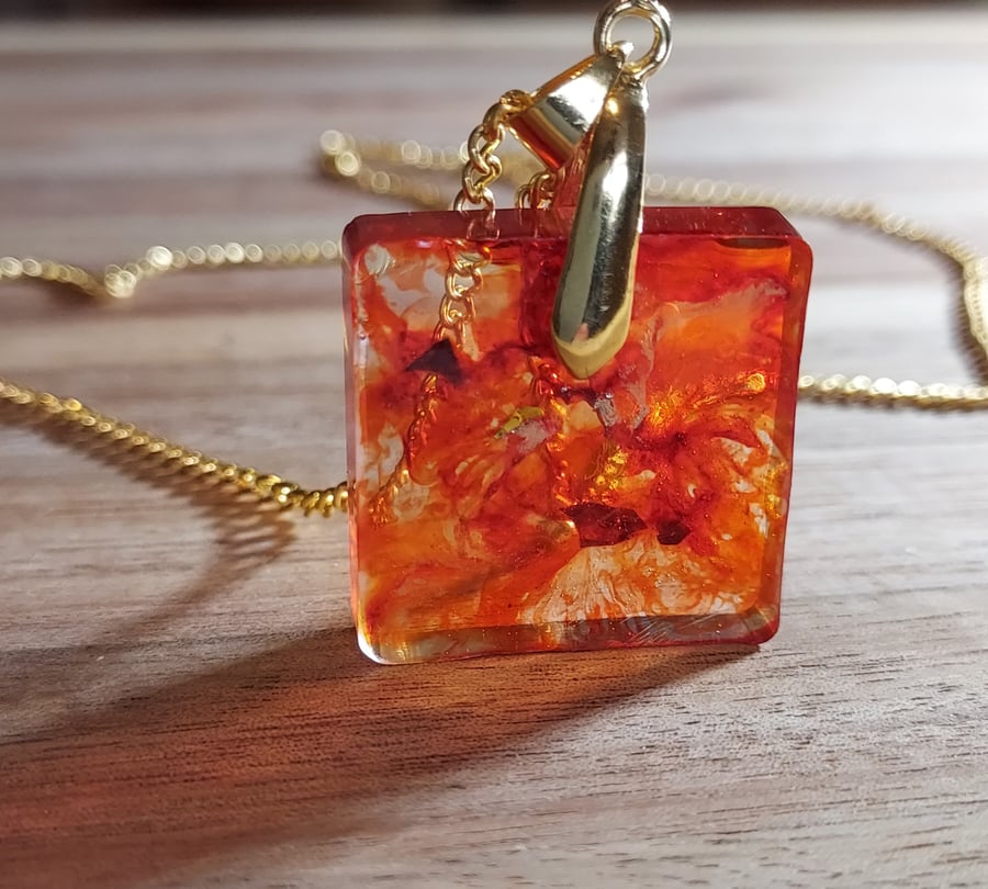 Simple square resin pendant necklace in shades of orange, coffee and gold. 