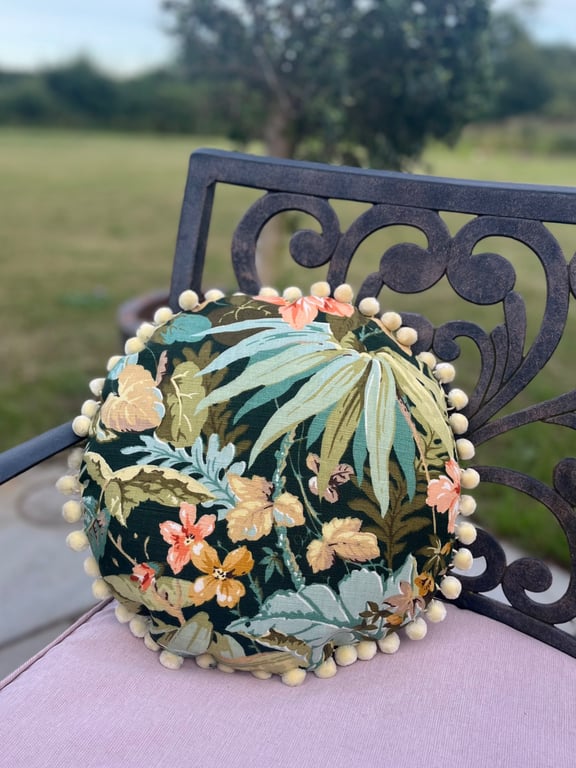Round feature cushion in vintage leafy linen with pompoms