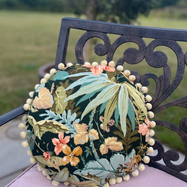 Round feature cushion in vintage leafy linen with pompoms