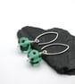 green and black polka dot lampwork glass earrings
