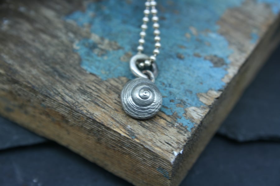 Tiny shell pendant or charm 