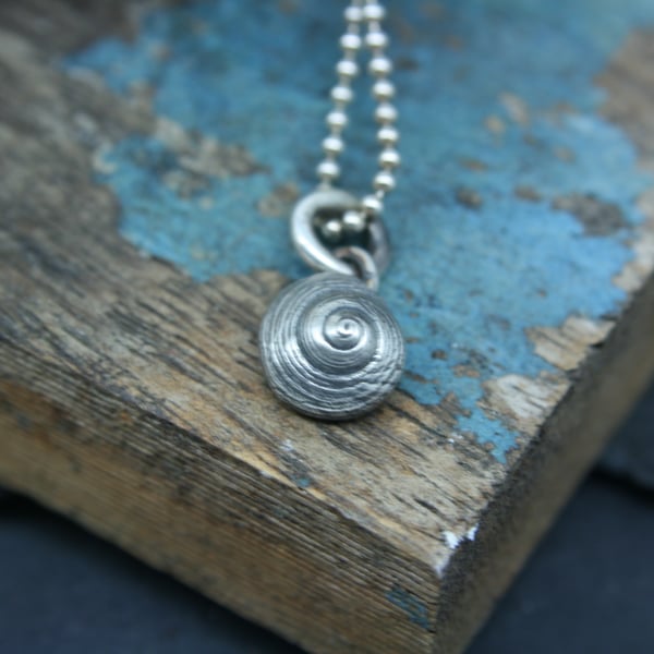 Tiny shell pendant or charm 