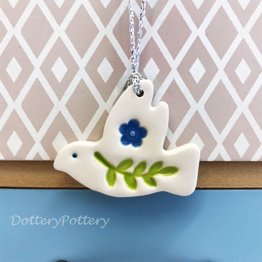 Teeny ceramic dove decoration with leaves and blue flower