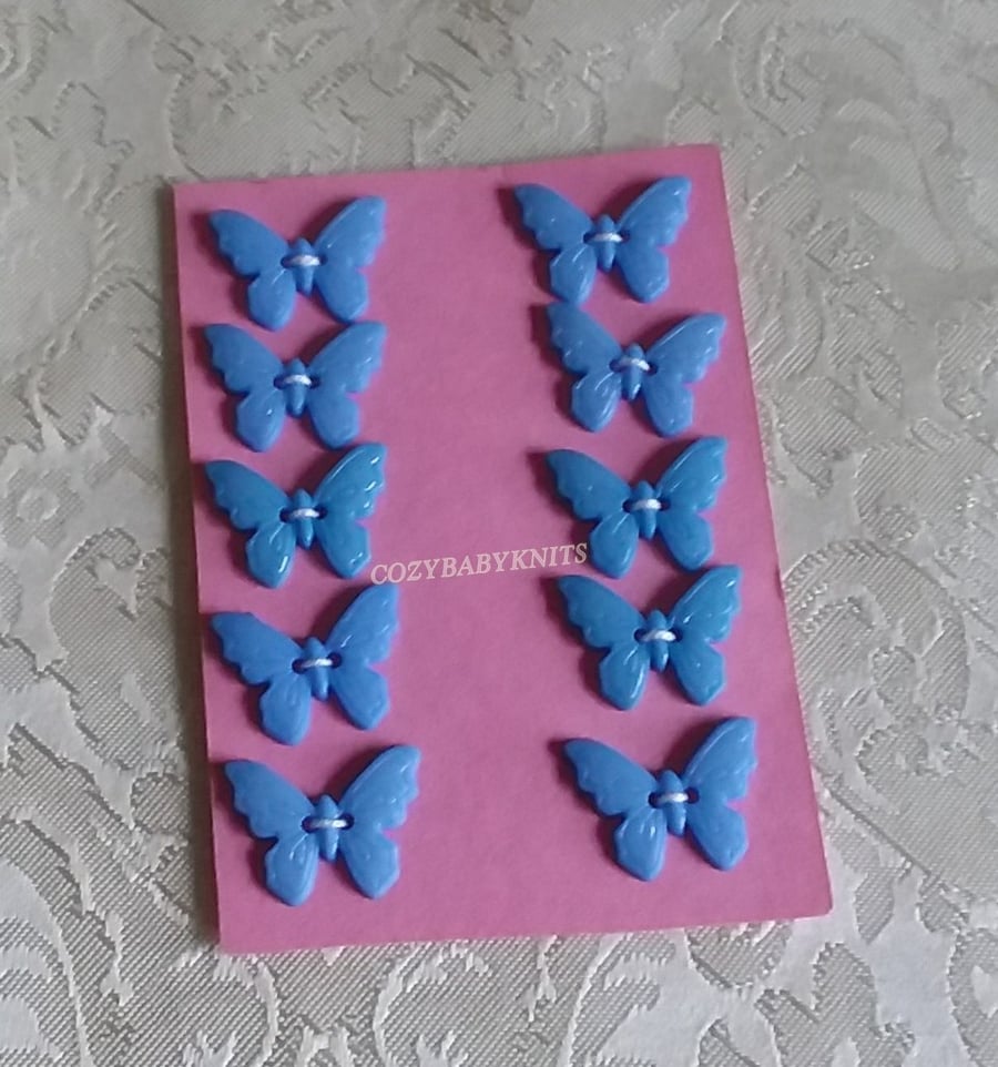 BLUE PLASTIC BUTTERFLY BUTTONS WITH TWO HOLES FOR ATTACHING 