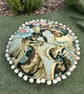 Round feature cushion in vintage leafy linen with pompoms - Image 4