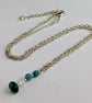 Dainty silver tone chain with green jade bead pendant