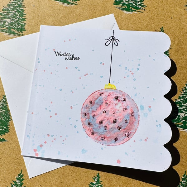 Watercolour art Christmas card with blue and pink glittery bauble 