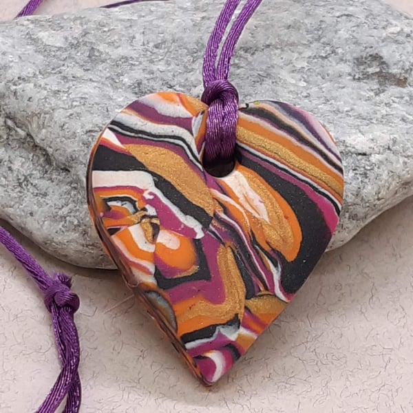 Orange, hot pink, gold and black heart polymer clay pendant