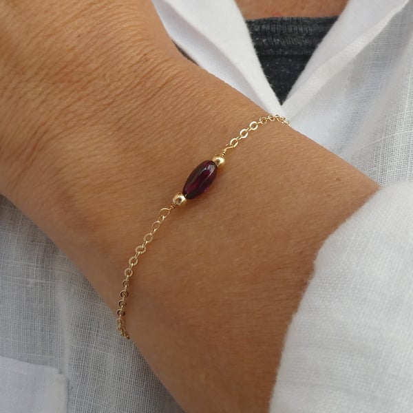 Gold chain and garnet gemstone bracelet