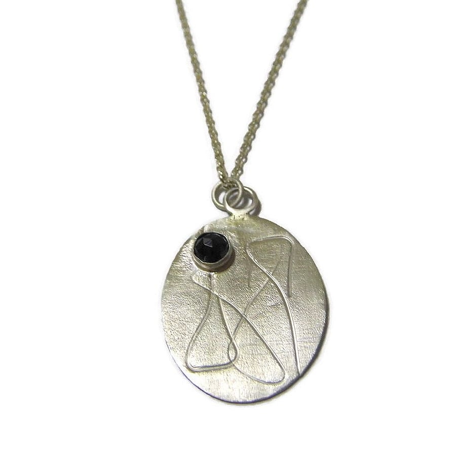 roller printed sterling silver oval pendant with rose cut black spinel