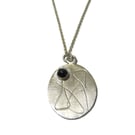 roller printed sterling silver oval pendant with rose cut black spinel