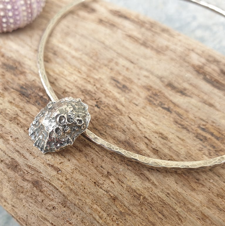Sterling silver textured bangle with limpet shell charm