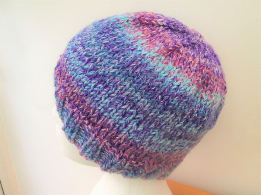 Hand knitted beanie hat in blue purple and pink colour changing yarn