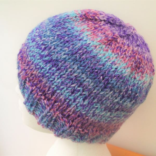 Hand knitted beanie hat in blue purple and pink colour changing yarn