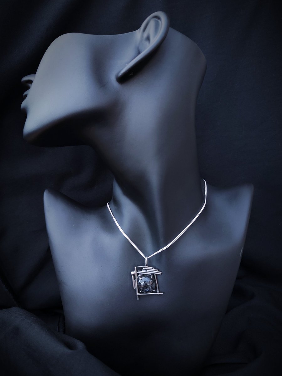Silver pendant with round rutilated quartz
