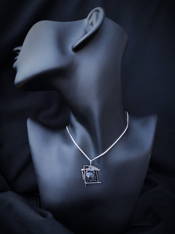 Silver pendant with round rutilated quartz