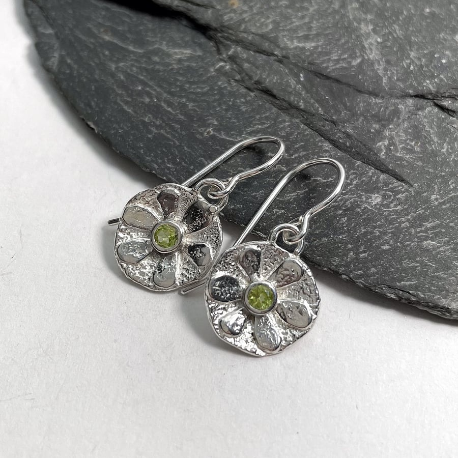 Small sterling silver flower earrings with peridot centres