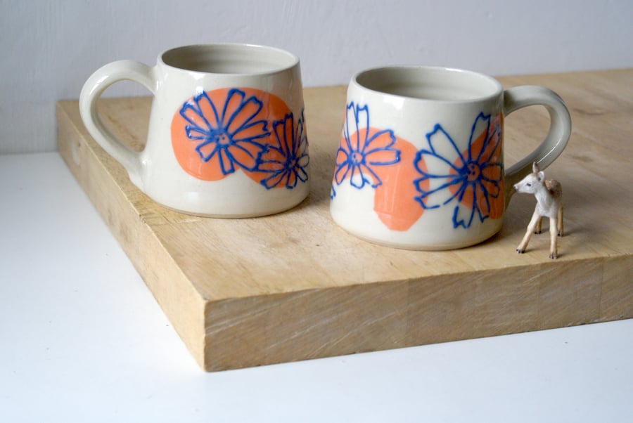 One hand thrown pottery mug with daisy flower motif
