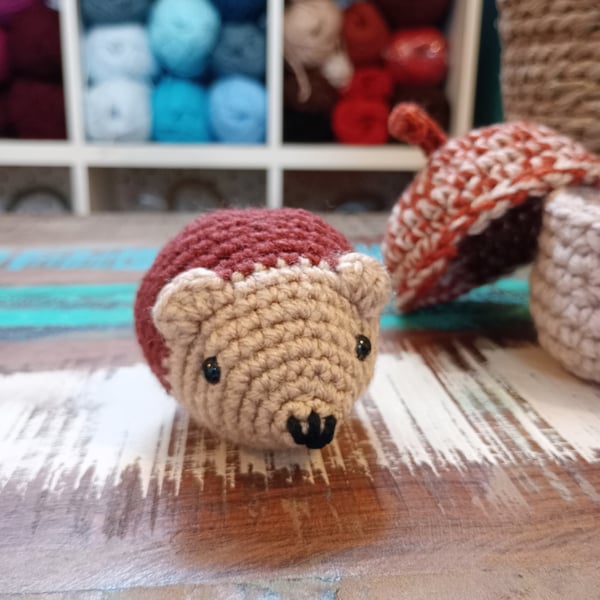 Hedgehog baby crochet amigurumi inside a tiny crochet basket