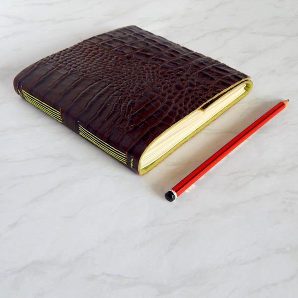 Crocodile Leather Sketchbook, shiny brown croc-print leather, green felt lining.