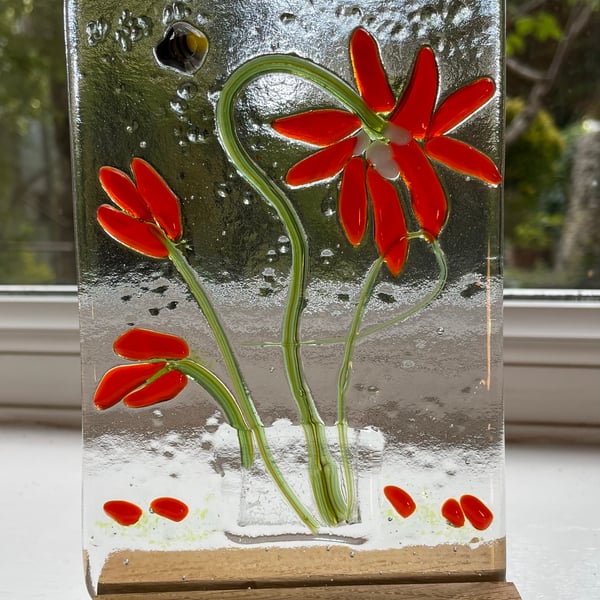 Fused glass vases of flowers