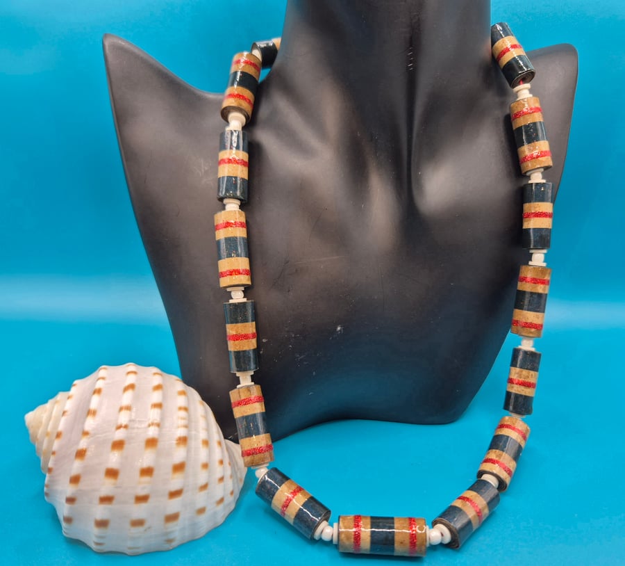 Necklace made of mottled brown paper with glittery red and blue stripes