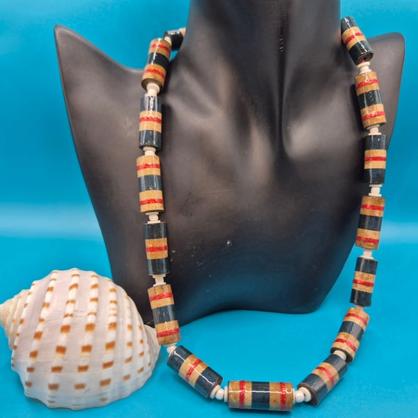 Necklace made of mottled brown paper with glittery red and blue stripes