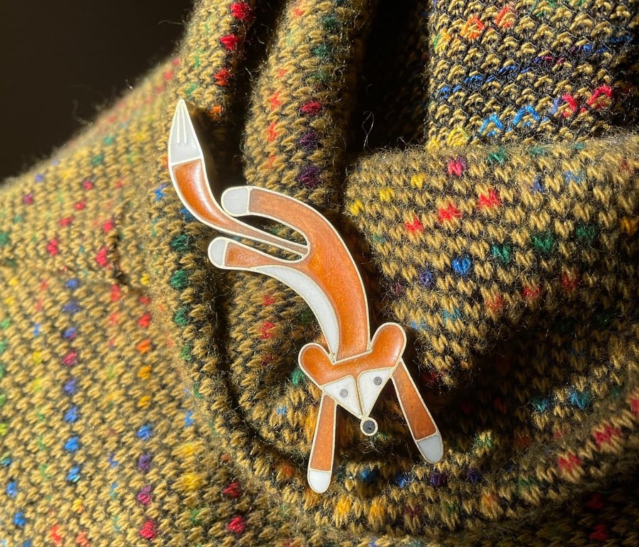 Leaping fox brooch in metal and resin.