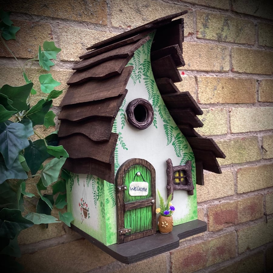 Cream and green bird house, fairy house, wooden bird box with window and door.  