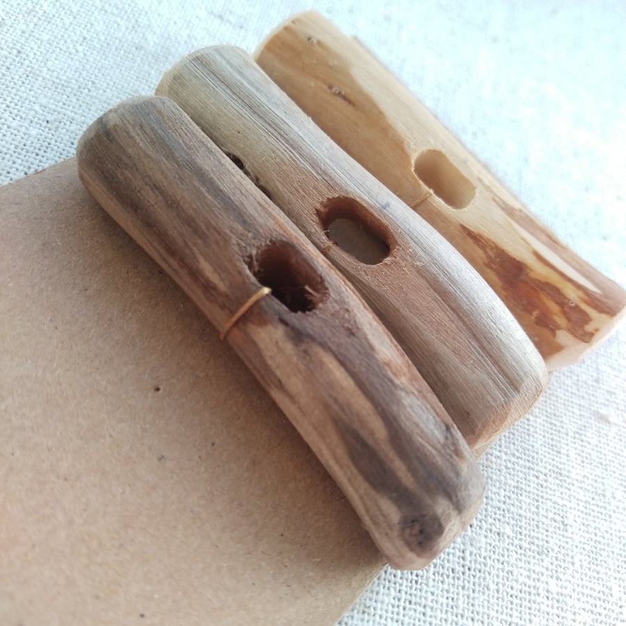 Three large mismached driftwood toggle buttons with single hole