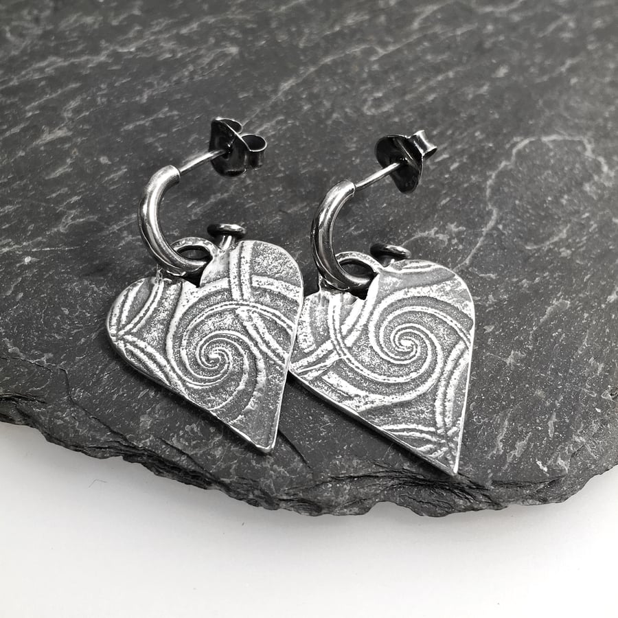 Sterling silver embossed heart earrings on a hoop stud