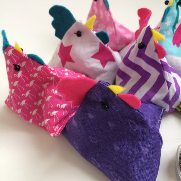 Pattern or paper weight bean bag chickens. Pink, purple and turquoise